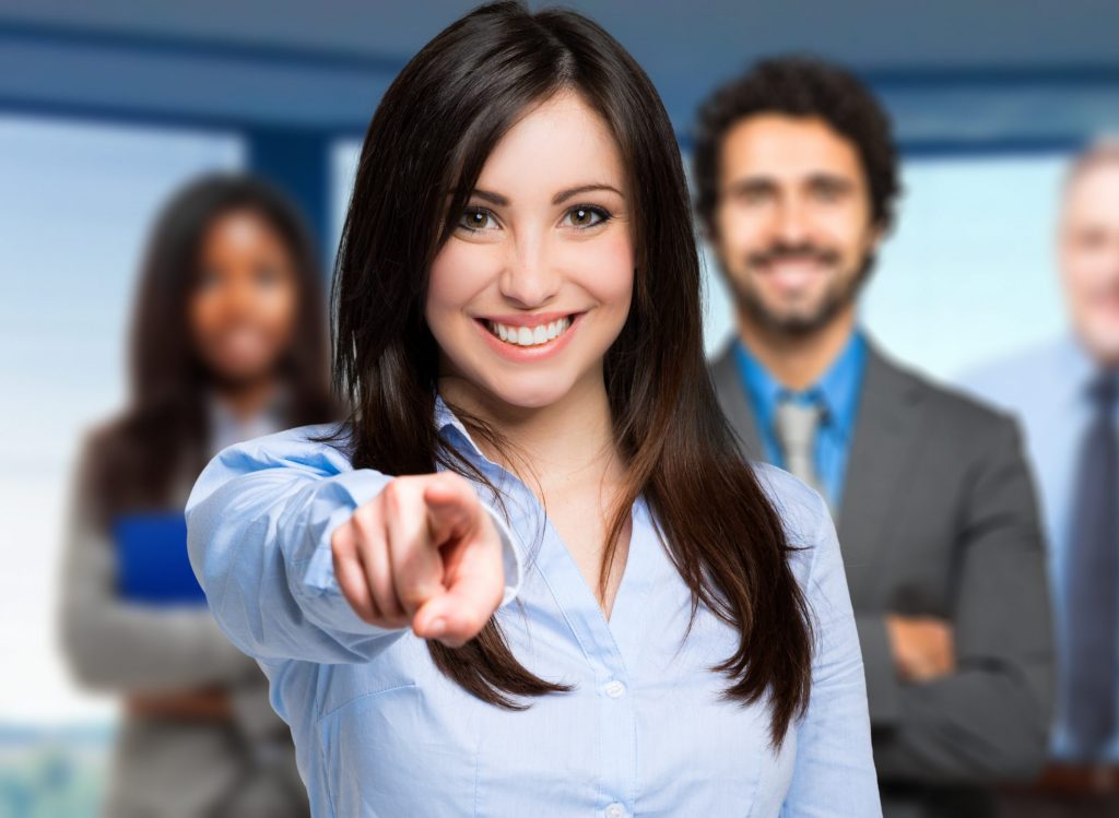 Smiling woman pointing her finger to you Smiling woman pointing her finger to you